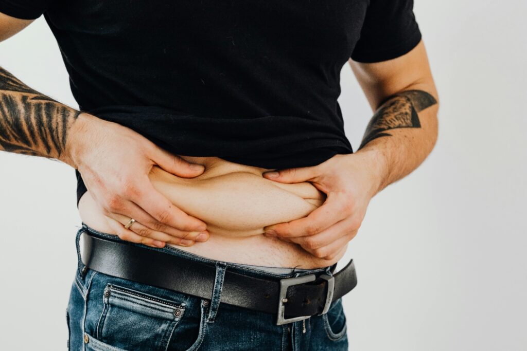 Man holding belly fat illustration of best way to lose fat and weight